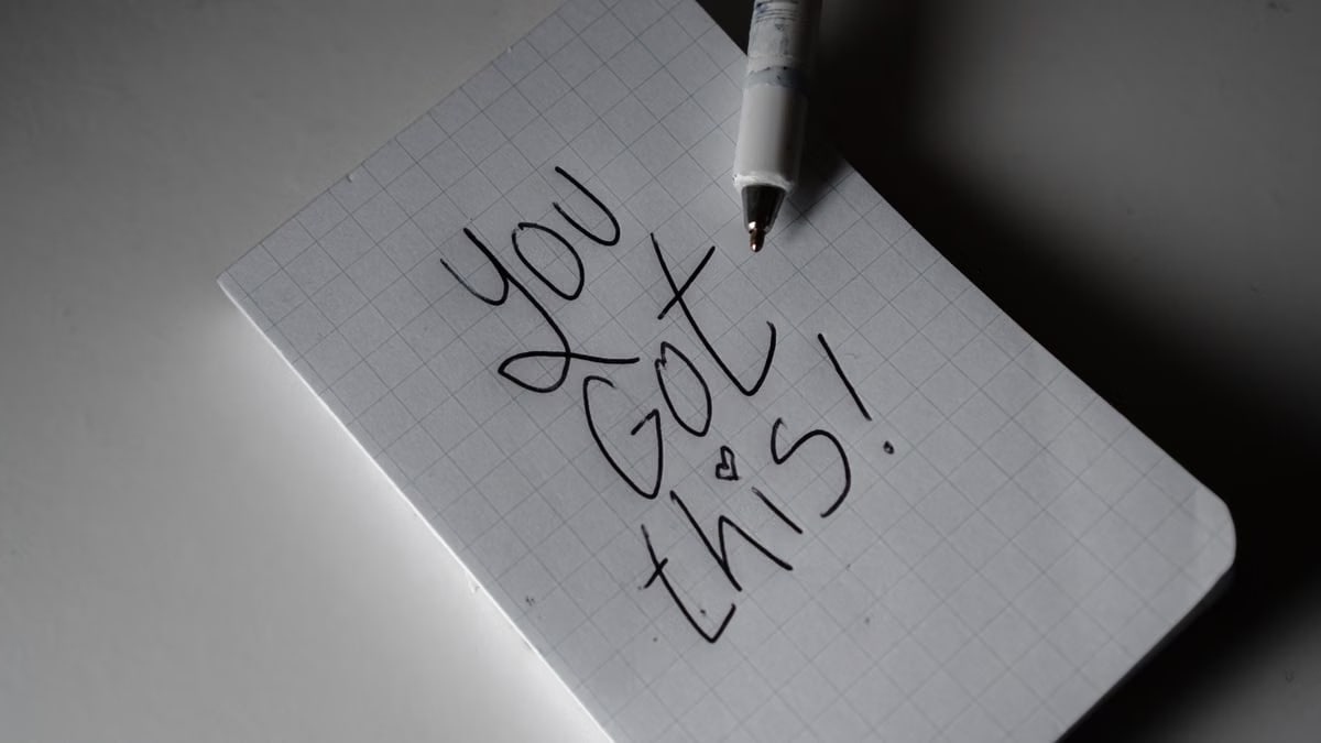 Inspirational handwritten note on graph paper with pen. Encouraging words 'You got this!'